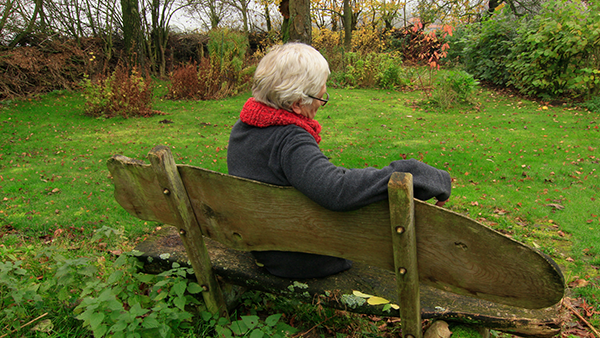 Older person sitting on bench